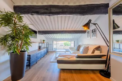 a living room with a couch and a table at Appart Hypercentre CLIM 2chb QuartierChic in Aix-en-Provence