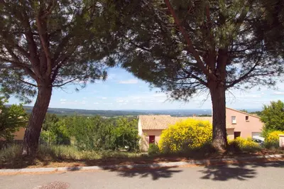 two trees in front of a house with a view at Que Passion in Blauvac