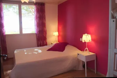 a bedroom with a white bed and a red wall at Que Passion in Blauvac