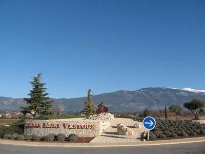 a sign in front of a park with mountains in the background at La maisonnette in Crillon-le-Brave