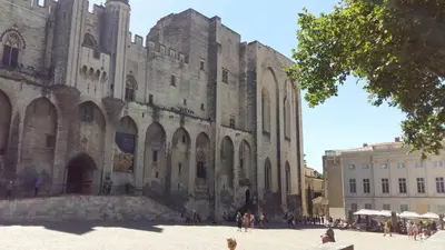a large building with people standing in front of it at La maisonnette in Crillon-le-Brave