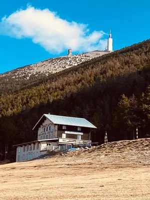a building on top of a hill with a lighthouse at La maisonnette in Crillon-le-Brave