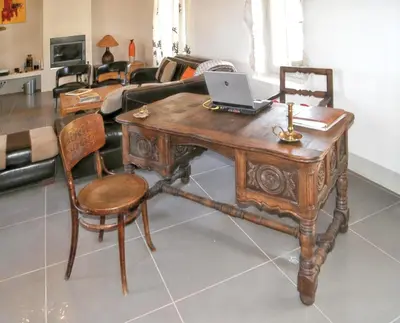 a wooden table with a laptop on it in a living room at Villa spacieuse à Oppède avec piscine et vue imprenable in Oppède