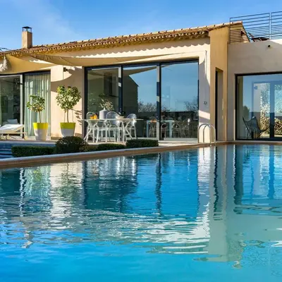 a swimming pool in front of a house at BB 12 LUBERON chambres d'hôtes contemporaines in Gordes