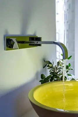 a bathroom sink with a faucet with water coming out at BB 12 LUBERON chambres d'hôtes contemporaines in Gordes