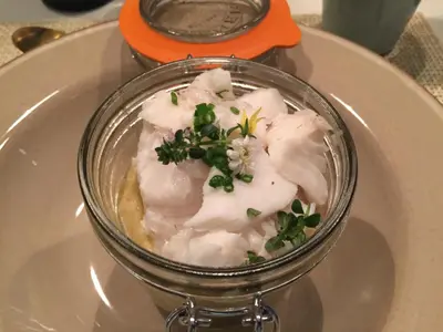 a glass dish of food on a plate on a table at BB 12 LUBERON chambres d'hôtes contemporaines in Gordes