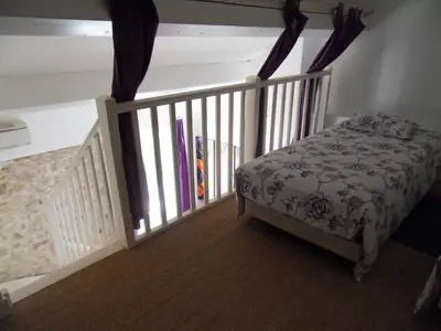 a small bedroom with a bed and a crib at Domaine de L'Olibaou in Venelles