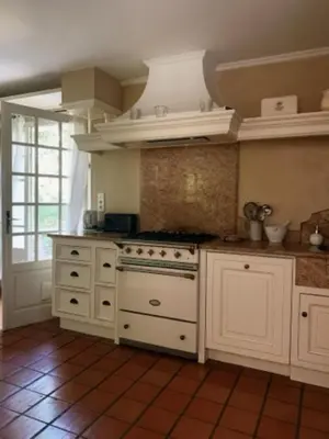 a kitchen with white cabinets and a stove at L'Hymette in Blauvac
