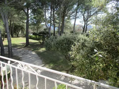 a path in a park with trees and bushes at L'Hymette in Blauvac