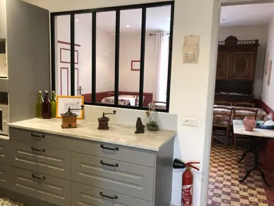 a kitchen with a dresser with a large window at Mas la Cigaliere in Venasque