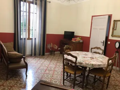 a dining room with a table and chairs in a room at Mas la Cigaliere in Venasque