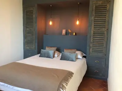 a bedroom with a bed with two pillows at La Calade in Lourmarin