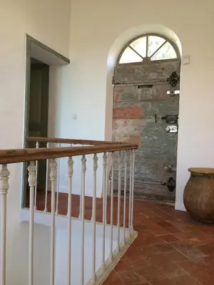 a stairway with a window and a wooden wall at La Calade in Lourmarin