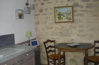 a kitchen with a table and a table and chairs at Lou mas li Pitchoun 