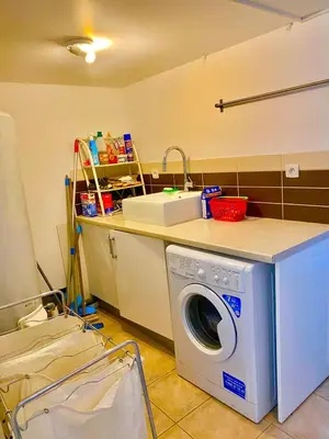 a laundry room with a washing machine on a counter at Villa Felin Feline in LʼIsle-sur-la-Sorgue
