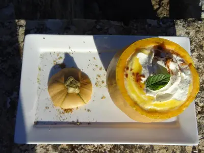 a white plate with a food item on it at Les Jardins d'Eleusis in Murs