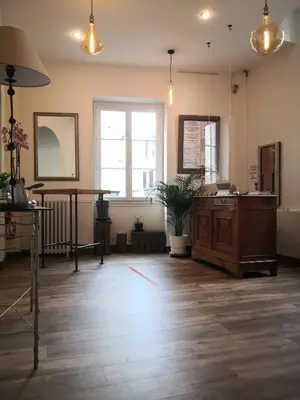 a large room with a wooden floor and a table at Grand Hôtel De La Poste in Salon-de-Provence