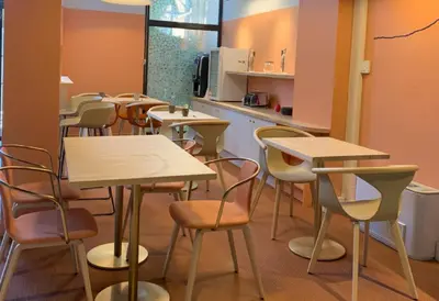 a classroom with tables and chairs and a kitchen at City Résidence Aix-en-Provence in Aix-en-Provence