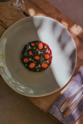 a cookie sitting on a plate on a table at Omma in Roussillon