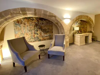 two chairs in a room with a painting on the wall at Hôtel des Augustins in Aix-en-Provence