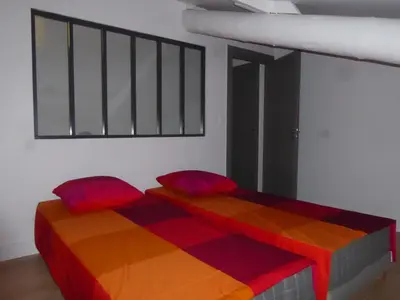 a bedroom with two beds with colorful cushions at The Panoramic House in Lagnes
