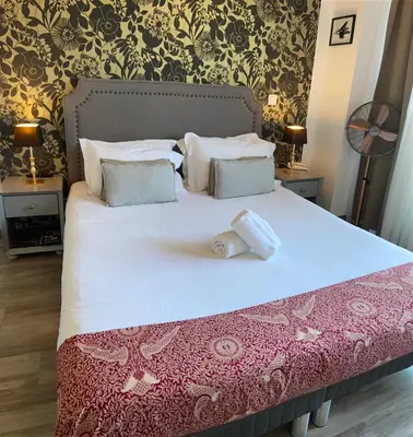 a bedroom with a large bed with white sheets and pillows at Les Terrasses D'Aix - Studio avec Grande Terrasse privée in Aix-en-Provence