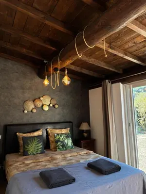a bedroom with a bed with towels on it at Villa Liberty in Entraigues-sur-la-Sorgue