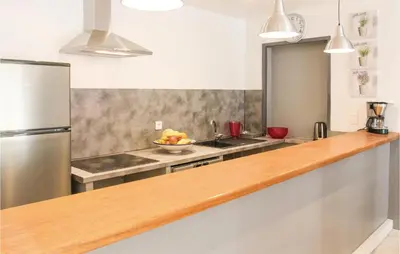 a kitchen with a counter with a bowl of fruit at Amazing Home In Lançon De Provence in Lançon-Provence