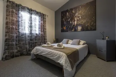a bedroom with a bed with two towels on it at Un Coin de Provence in LʼIsle-sur-la-Sorgue