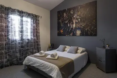 a bedroom with a bed with two towels on it at Un Coin de Provence in LʼIsle-sur-la-Sorgue