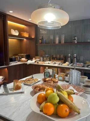 a hotel room with a bed and a desk and a television at Hôtel Rotonde Aix-en-Provence centre in Aix-en-Provence