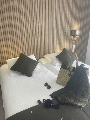 a hotel room with two beds with sandals and a purse at Les Loges du Luberon in Coustellet