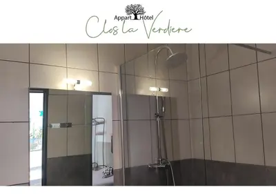 a bathroom with a shower and a mirror at Le Clos la Verdière in Velaux