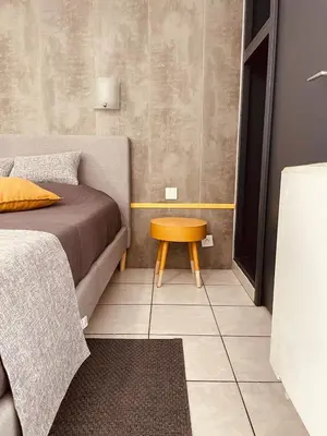 a small bedroom with a bed and a table at Le Clos la Verdière in Velaux