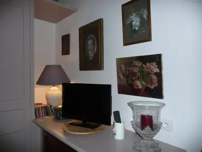 a kitchen with a microwave and a table with plates at La Cordière in Lourmarin