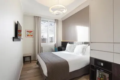 a hotel room with a bed and a window at Negrecoste Hôtel & Spa in Aix-en-Provence