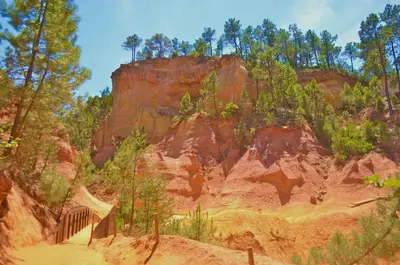 a painting of a mountain with trees and a bridge at Ferme St Roch in Robion en Luberon