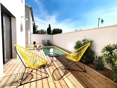a patio with yellow chairs and a swimming pool at Les Loges En Provence 