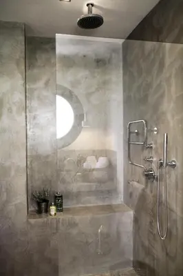 a bathroom with a shower with a glass wall at Les Loges En Provence 