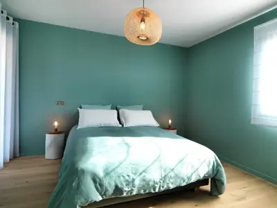 a bedroom with blue walls and a large bed at Les Loges En Provence 