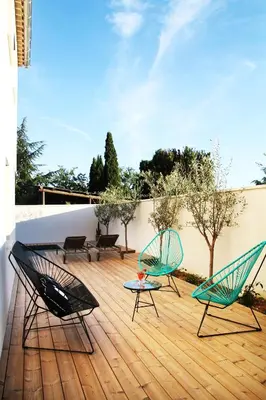 two chairs and a table on a deck at Les Loges En Provence 