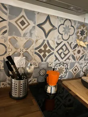 a kitchen counter with utensils on a wall at Le cœur de Lourmarin Loulou en Luberon in Lourmarin