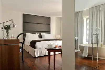 a bedroom with a large bed and a bath tub at La Maison d'Aix 1785 - Hôtel Particulier & Spa in Aix-en-Provence