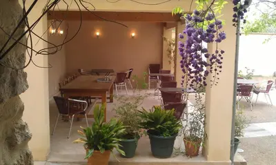 a patio with a table and potted plants at le clos du Patre in Caromb