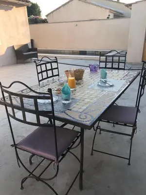a table with two chairs and two candles on it at Villa Jasmin in Carpentras