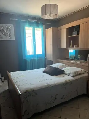 a bedroom with a large bed with a blue wall at Villa Jasmin in Carpentras