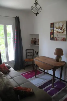a living room with a couch and a table at Mas des Mûriers in Saumane-de-Vaucluse