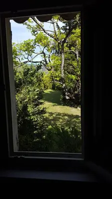 a window with a view of a field and trees at Mas des Mûriers in Saumane-de-Vaucluse