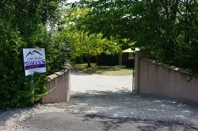 a fence with a sign on the side of it at La belle histoire Gîte Ventoux in Bédoin