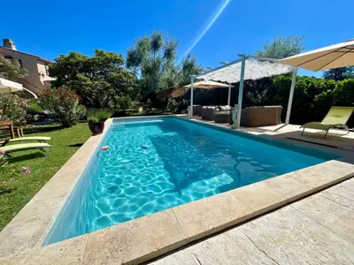 a swimming pool in the backyard of a house at La belle histoire Gîte Ventoux in Bédoin